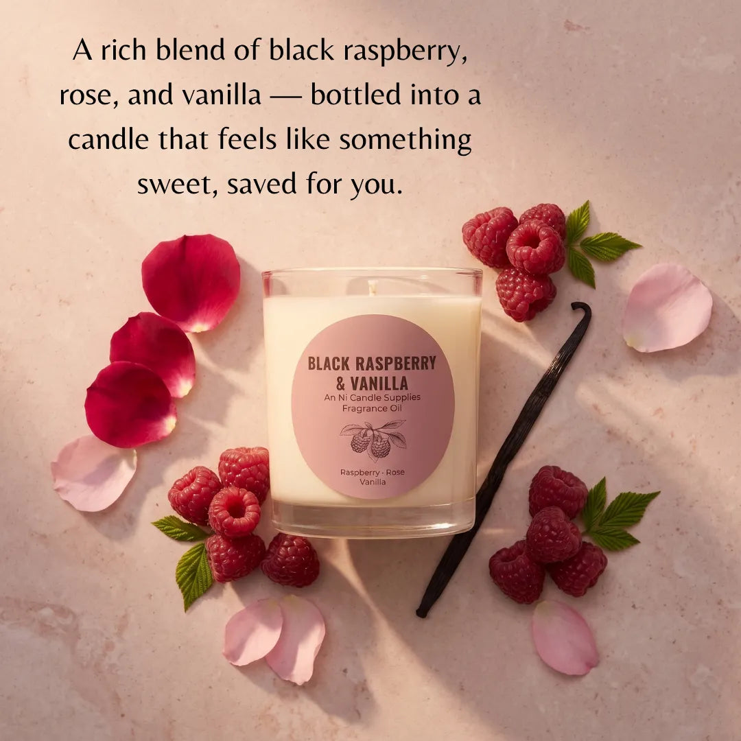 A glass jar candle labeled 'Black Raspberry & Vanilla' is styled on a light stone surface with raspberries, rose petals, a vanilla bean, and text describing the scent. No person or real environment is present, so this is Product/Packaging rather than Lifestyle.
