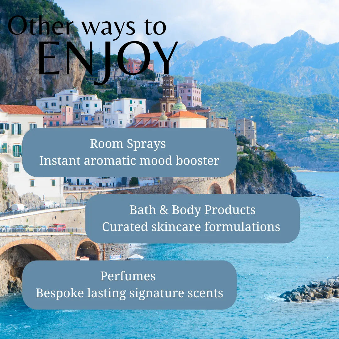 Scenic view of a coastal town with mountains in the background, featuring text about room sprays, bath & body products, and perfumes.