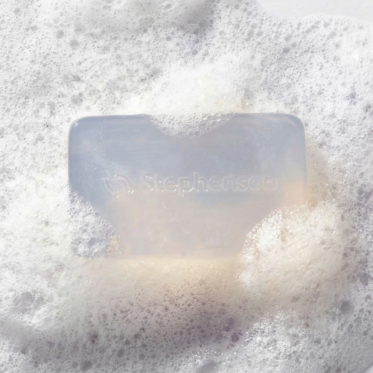 Bar of soap with 'Stephenson's' branding on a foamy background
