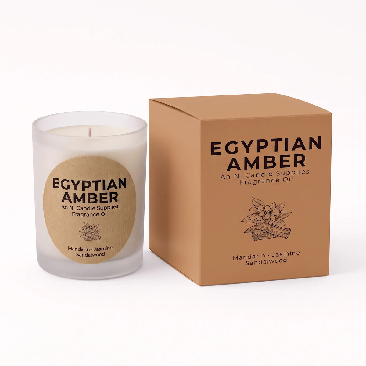 A frosted glass candle jar with white wax and a round kraft paper label reading 'EGYPTIAN AMBER' stands next to its matching brown cardboard box on a clean white background.