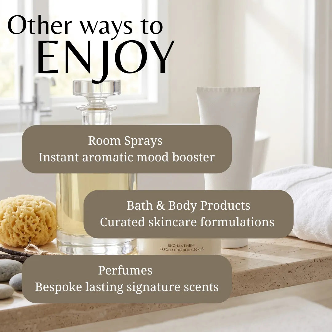 Promotional graphic for Enchanted Scents featuring a glass bottle of room spray, a white tube, a bath sponge, and stones on a countertop with text overlays reading 'Other ways to ENJOY' and categories for room sprays, bath & body products, and perfumes.