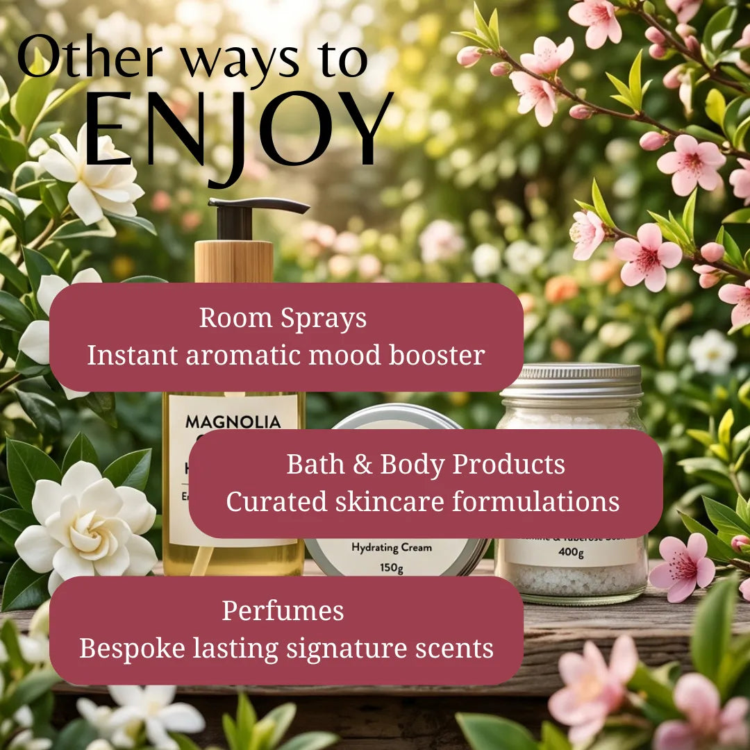 Promotional graphic for bath and body products with three jars and a pump bottle arranged on a wooden surface outdoors among green leaves and pink flowers. Large text reads 'Other ways to ENJOY' and callouts mention room sprays, bath & body products, and perfumes.