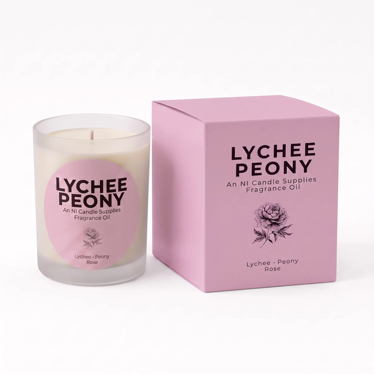 A Lychee Peony scented fragrance oil candle in a frosted glass jar next to its pink packaging box, featuring a pink circular label on the candle and black text on the box.