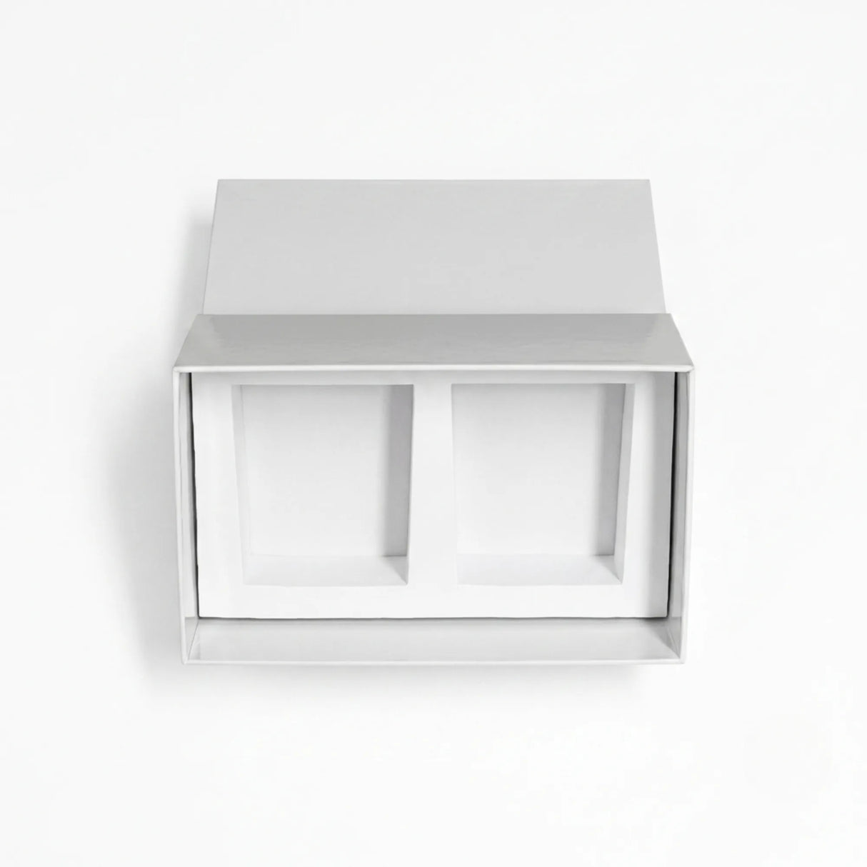 A minimalist white drawer style candle gift set box with two recessed compartments inside, shown against a clean white background.