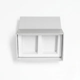 A minimalist white drawer style candle gift set box with two recessed compartments inside, shown against a clean white background.