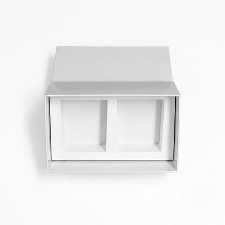 A minimalist white drawer style candle gift set box with two recessed compartments inside, shown against a clean white background.