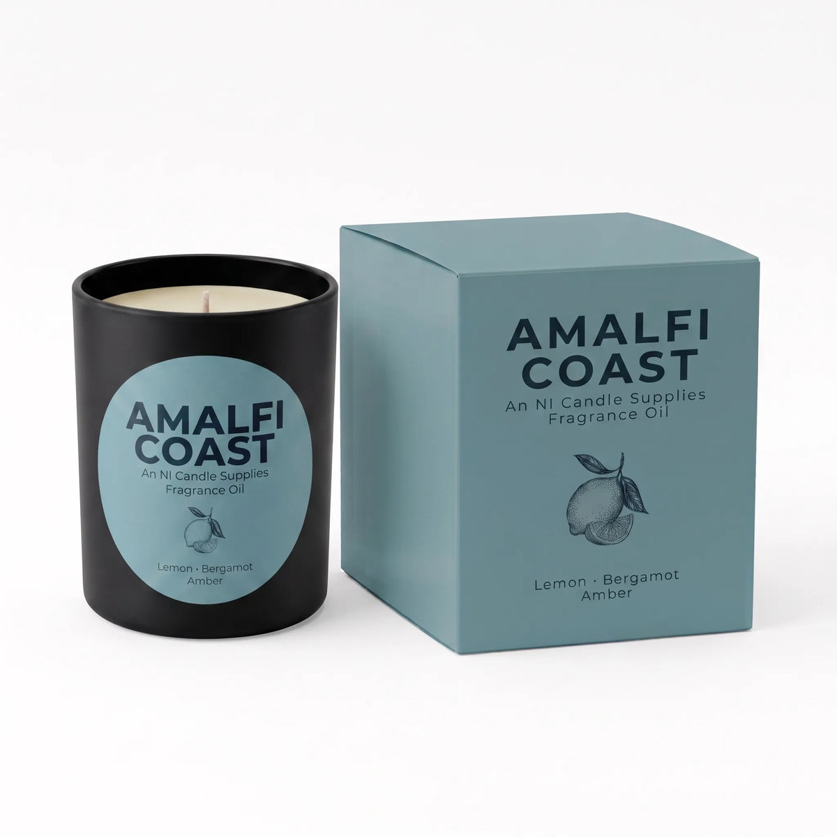 A black candle jar with a light blue circular label next to its matching light blue box, both printed with the brand name AMALFI COAST and scent name Lemon Bergamot Amber.