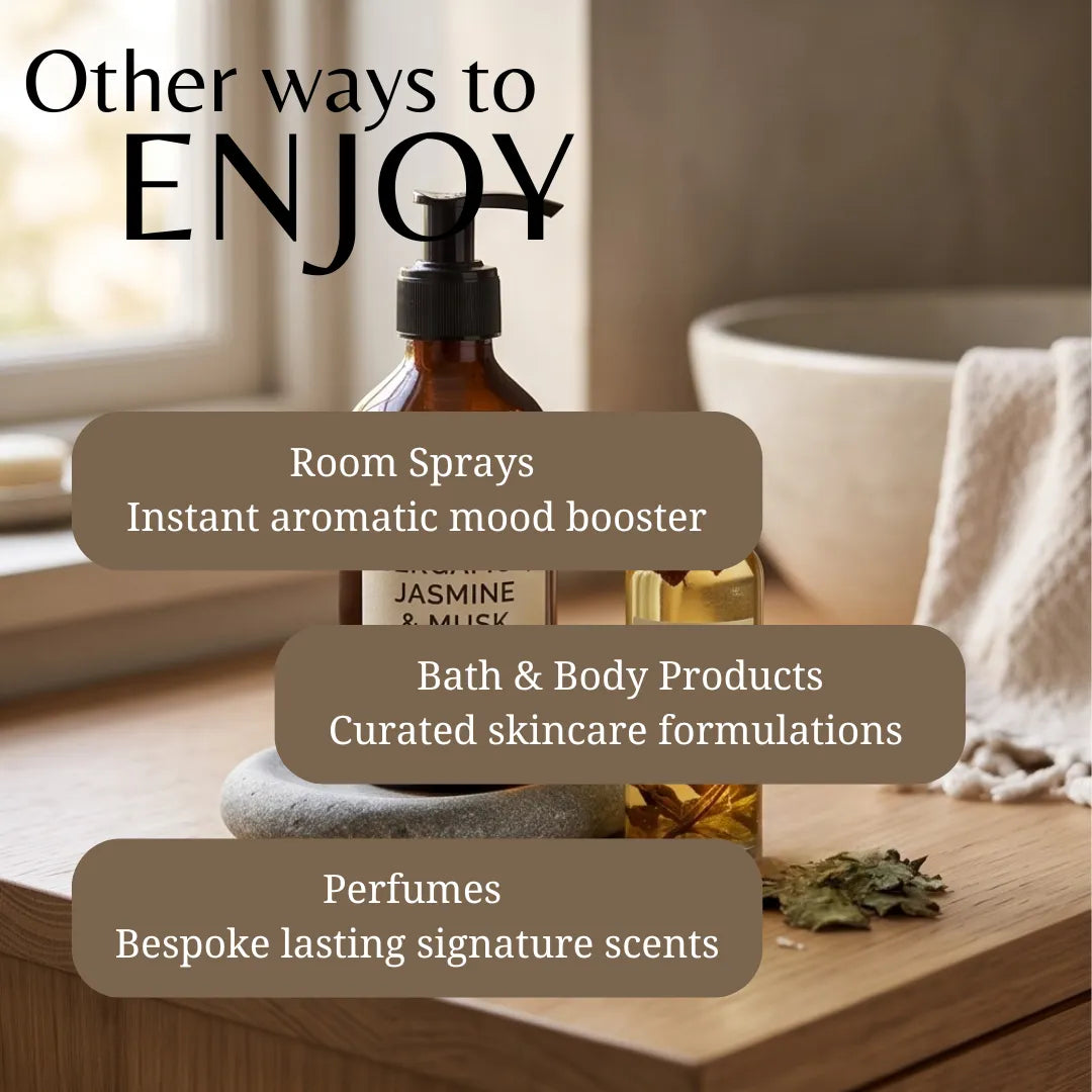 An amber glass pump bottle labeled 'JASMINE & MUSK' sits on a wooden surface in a softly lit bathroom-like setting, with overlaid text reading 'Other ways to ENJOY' and callouts for room sprays, bath & body products, and perfumes.