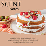 A layered cake topped with sliced strawberries, whipped cream, and small white flowers, presented on a plate with a bowl of strawberries beside it. Large text at the top reads 'SCENT Notes:' and flavor notes are listed below on a peach background.