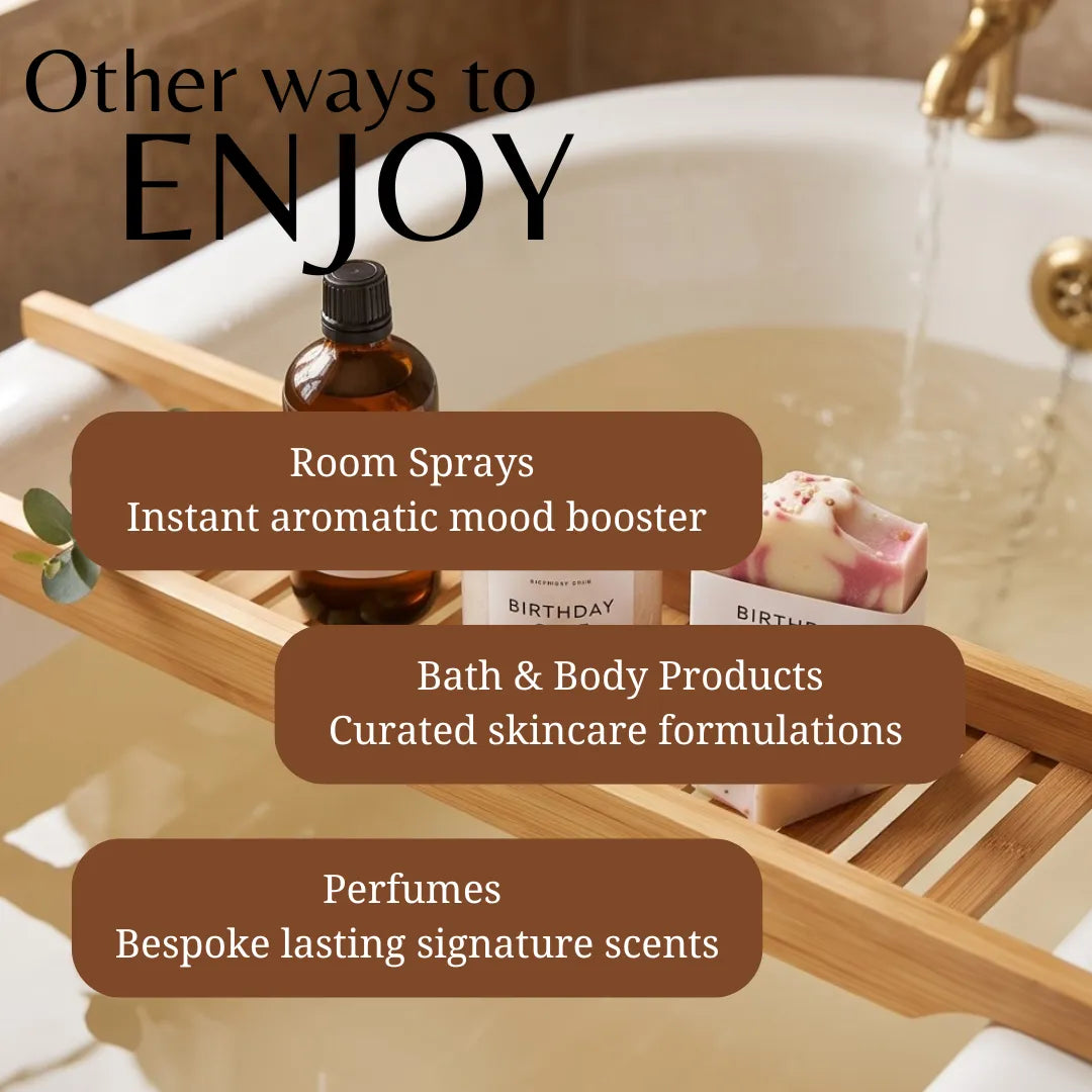 Promotional graphic for home fragrance and bath products, showing a wooden bath caddy over a bathtub with an amber spray bottle, a bar of soap, and overlaid text reading 'Other ways to ENJOY' plus categories for room sprays, bath & body products, and perfumes.