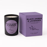 A black glass candle jar with a lavender label next to its matching purple box, labeled 'Black Amber & Lavender' by An N Candle Supplies, on a white background.