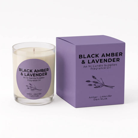 A glass jar candle with cream-colored wax and a purple circular label next to its purple packaging box, both labeled 'BLACK AMBER & LAVENDER' by An NI Candle Supplies.