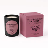 A black candle jar with a pink circular label next to its matching pink box, labeled 'Black Raspberry & Vanilla' by An Ni Candle Supplies, on a white background.