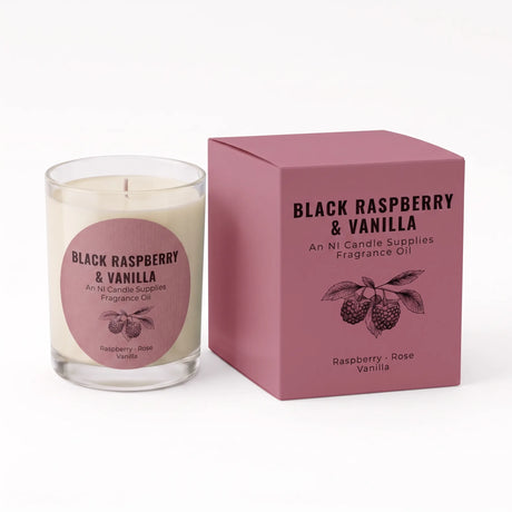 A glass jar candle with cream-colored wax and a pink circular label next to its matching dusty pink packaging box. The labels and box are printed with 'BLACK RASPBERRY & VANILLA' and 'An Ni Candle Supplies Fragrance Oil' along with a raspberry illustration.