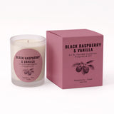A frosted glass candle jar with cream wax and a pink circular label next to its matching dusty pink box, both printed with 'BLACK RASPBERRY & VANILLA' and a raspberry illustration. The label also includes 'An Ni Candle Supplies' and 'Fragrance Oil'.