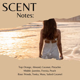 Scent Notes: fragrance artwork featuring a woman seen from behind on a beach at sunset, with beige text blocks and listed scent notes including orange, almond, coconut, pistachio, jasmine, freesia, peach, woods, tonka, moss, and salted caramel.