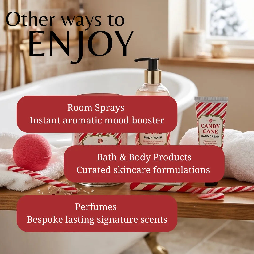 Promotional graphic for a bath and body product collection in a bathroom setting. The scene shows a pump bottle, a tube labeled 'CANDY CANE HAND CREAM,' a red bath bomb, rolled towels, and candy cane props on a wooden bench beside a bathtub.