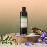 A bottle of 'Capri Shores' fragrance oil on a wooden platform with decorative elements.