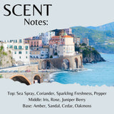 Scenic view of a coastal town with mountains in the background, featuring the word 'SCENT' and fragrance notes.