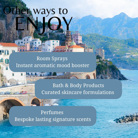 Scenic view of a coastal town with mountains in the background, featuring text about room sprays, bath & body products, and perfumes.
