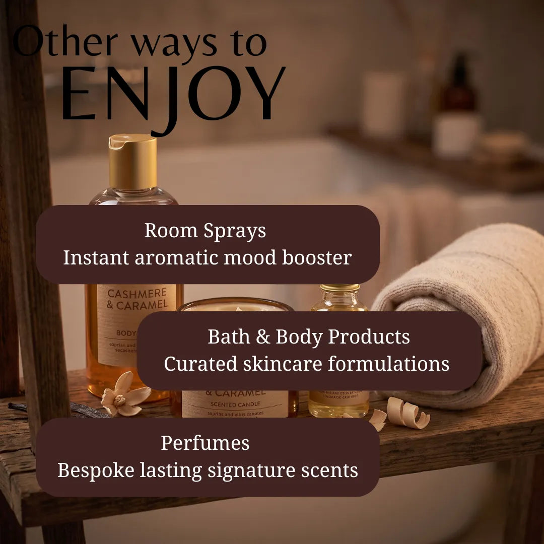 A promotional graphic for a spa or wellness product collection, showing several amber glass bottles and jars on a wooden shelf beside a rolled cream towel. Large overlaid text reads 'Other ways to ENJOY' with bullet points for 'Room Sprays', 'Bath & Body Products', and 'Perfumes'.