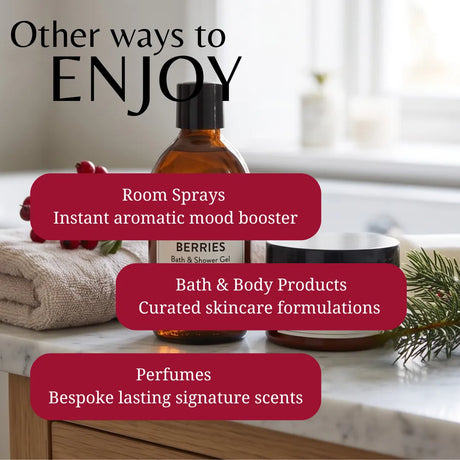 An amber glass bottle of BERRIES Bath & Shower Gel is displayed on a marble countertop with a folded towel, a candle, and holiday greenery in a bright bathroom setting. Large text overlays read 'Other ways to ENJOY' and list features like room sprays, bath & body products, and perfumes.