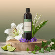 Cotswold Lee fragrance oil bottle with flowers and limes on a wooden stand