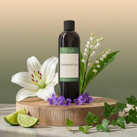 Cotswold Lee fragrance oil bottle with flowers and limes on a wooden stand