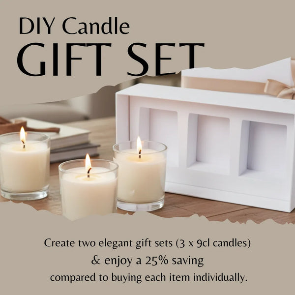 DIY candle gift set with three lit candles and a white box on a wooden surface.