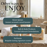 Promotional graphic for wellness and spa products showing a bathroom scene with a pump bottle, rolled towel, and hand & body soap bar labeled Honey Blossom, overlaid with text about room sprays, bath & body products, and perfumes.