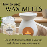 A labeled glass jar of wax melts sits beside a white ceramic wax warmer with a lit tea light candle on a wooden surface. Large text at the top reads 'How to use: WAX MELTS' and the bottom text says to use a 10% fragrance oil load for deep, long-lasting aroma.