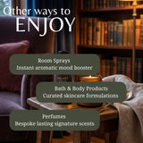 Promotional graphic with the text 'Other ways to ENJOY' over a cozy indoor scene featuring a bookshelf, armchair, table, candle, and draped fabric. Three dark olive text boxes list: Room Sprays, Bath & Body Products, and Perfumes.