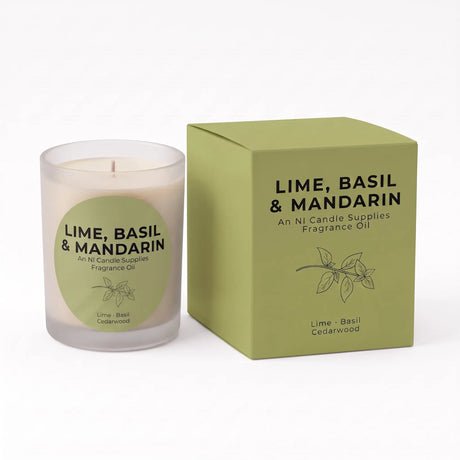 A litless fragrance oil candle in a frosted glass jar next to its olive green packaging box, labeled 'LIME, BASIL & MANDARIN' by Ni Candle Supplies.