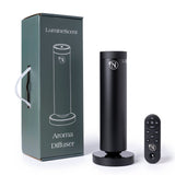 Black aroma diffuser with remote control and packaging on a white background