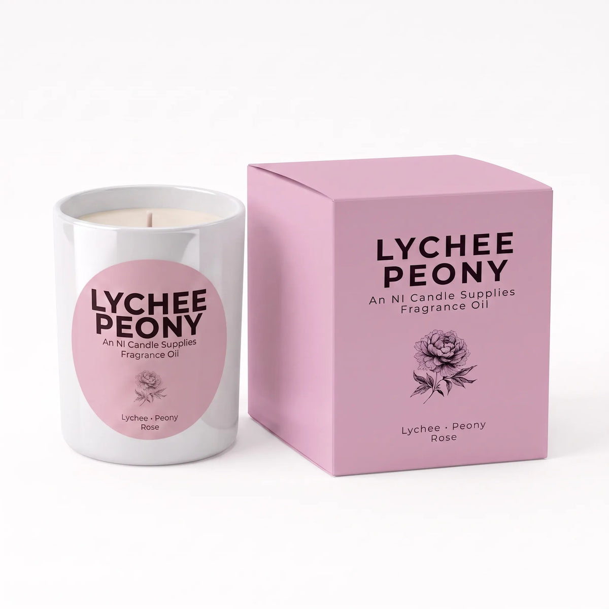 A white glass candle jar with a pink circular label next to its matching pink box, both printed with the text 'LYCHEE PEONY' and a rose illustration, on a clean white background.