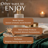 A spa-style promotional graphic with the text 'Other ways to ENJOY' over bath and body product props, including a frosted room spray bottle, a gold-capped jar, a folded towel, and a stone slab on dark green fabric. Three brown callout boxes list: Room Sprays, Bath & Body Products, and Perfumes.