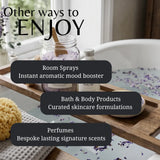 Promotional graphic for a spa or wellness product collection, showing a wooden bath tray with a jar of lavender bath salts, a small body oil bottle, and a sponge in a bathtub with lavender petals. Large text reads 'Other ways to ENJOY' with bullet points for 'Room Sprays', 'Bath & Body Products', and 'Perfumes'.