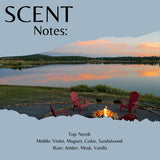 Scent Notes: cover art featuring a scenic lake sunset with red Adirondack chairs around a campfire, plus text listing fragrance notes: Top: Neroli, Middle: Violet, Muguet, Cedar, Sandalwood, Base: Amber, Musk, Vanilla.