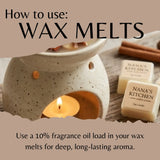 Wax melt burner with lit candle and wax melts labeled 'Nana's Kitchen' on a wooden surface.
