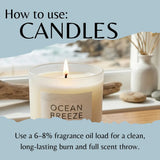 A lit glass candle labeled 'OCEAN BREEZE' with overlaid text reading 'How to use: CANDLES' and usage instructions below, set against a soft blue graphic background with a blurred window scene behind the candle.