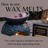 An instructional graphic showing a teal ceramic wax warmer with a lit candle inside, alongside a black box labeled 'Oriental Blossom Wax Melts.' Large text reads 'How to use: WAX MELTS' and additional text explains using fragrance oil load for deep, long-lasting aroma.