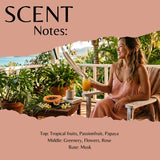 Scent note card for Passionfruit and Paw Paw fragrance oil. Notes are: top - tropical fruits, passionfruit and papaya. Mid - greenery, flowers and rose. Base - musk. The card shows a lady sitting in a chair on a tropical veranda.