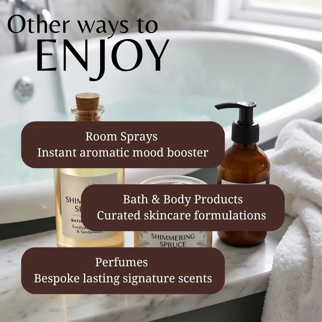 Promotional graphic for bath and body products showing a room spray bottle, amber bath product bottle, and perfume bottle arranged on a marble surface beside a white towel in front of a bathtub. Large text reads 'Other ways to ENJOY' with callouts for room sprays, bath & body products, and perfumes.