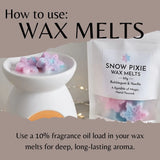 Instructional graphic showing how to use wax melts, featuring a white ceramic bowl filled with pink and blue star-shaped wax melts next to a white bag labeled 'SNOW PIXIE WAX MELTS' on a taupe background with text instructions.