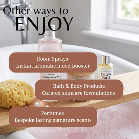 A promotional graphic showing bath and room fragrance products arranged on a wooden tray in a bathtub with bubbles. Text overlays read 'Other ways to ENJOY' and list categories: Room Sprays, Bath & Body Products, and Perfumes.