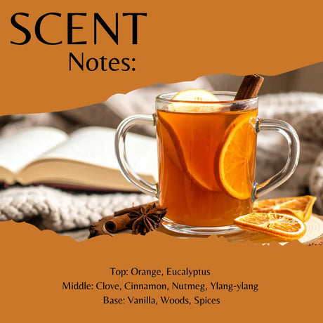 Scent profile graphic for a warm beverage blend, featuring a glass mug filled with orange tea, orange slices, cinnamon sticks, and star anise on a cozy blanket background. The top reads 'SCENT Notes:' and the bottom lists fragrance notes: Top: Orange, Eucalyptus; Middle: Clove, Cinnamon, Nutmeg, Ylang-ylang; Base: Vanilla, Woods, Spices.