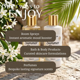 Two cosmetic bottles labeled Summer 150ml, one with a gold cap and one with a white cap, displayed on a stone surface with tropical leaves and white flowers. Text overlays mention room sprays, bath & body products, and perfumes.