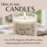 A lit candle in a clear glass jar with a cream-colored wax and a beige label reading 'Sweet Pea & Jasmine.' Large text at the top says 'How to use: CANDLES,' and smaller text at the bottom explains fragrance oil load recommendations.