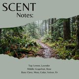 Scent profile graphic titled 'SCENT Notes:' showing a forest path scene with text listing fragrance notes: Top: Lemon, Lavender; Middle: Grapefruit, Rose; Base: Clove, Moss, Cedar, Vetiver, Fir.