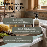 A promotional collage for bath and body products in a bathroom setting. Large text reads 'Other ways to ENJOY' over a bathtub, with labels for room sprays, instant aromatic mood booster; bath & body products including grounding soap bar, forest, and hand & body lotion; and perfumes, bespoke lasting signature scents.